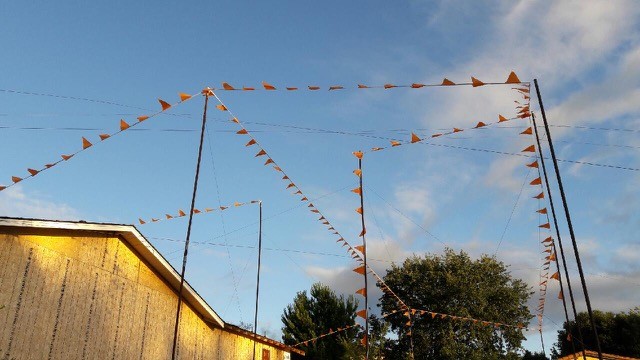 orange flag on ropestied between upright pole.show where new building will be constructed