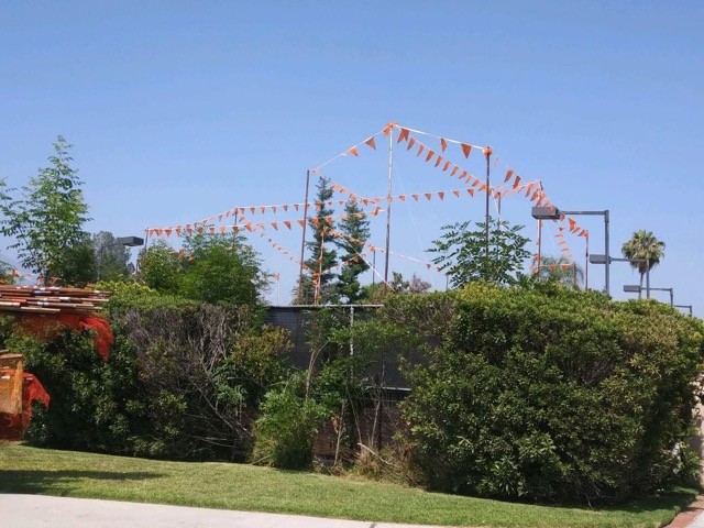 verticle poles arranged oversingle storyhouse showing the use of story poles in constructing add-ons view from behind the house